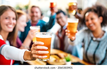 Blurred Background Of Friends Drinking And Toasting Beer At Brewery Bar Restaurant Patio - Happy Hour Promotion Concept With People Having Fun Together At Brew Out Door Pub - Focus On Lower Pint Glass