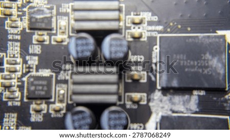 Blurred background of GPU electronic circuitry, showing abstract technology pattern and futuristic computer hardware texture.;