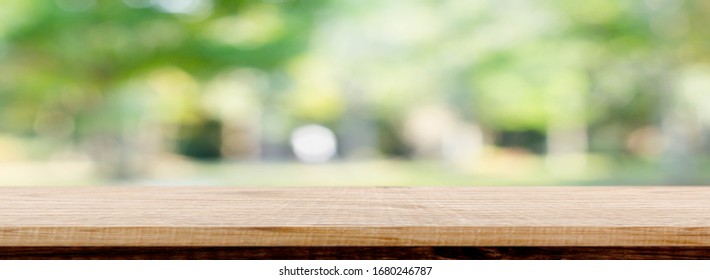 Blurred Background Of Green Park In Summer, Wood Table Top On Shiny Bokeh Green Background. For Product Display