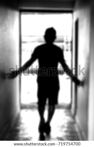 blurred background of a guy walking through tunnel toward the light, concept of light at the end of the tunnel, never giveup
