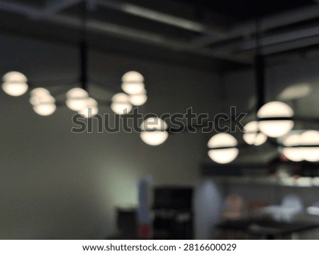 blurred background hanging light bulbs with dim light indoor