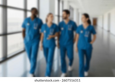 blurred for background Healthcare Team Walking in Hospital Hallway. Diverse Medical Professionals in Scrubs, Smiling and Collaborating. Confident Doctors and Nurses Discussing Patient Care. Teamwork