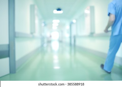 Blurred Background With A Hospital Corridor And A Moving Person.