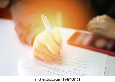 Blurred Background Image Of Education Concept Related To Reading And Writing/ Cheating In Reading Class With Mobile Phone / Young Learner Using Cellphone In The Study Room/ Defocused Academic Picture