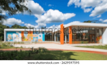 Blurred background of image features a modern charter school in brazil, showcasing vibrant architecture and a welcoming atmosphere for students and the community.