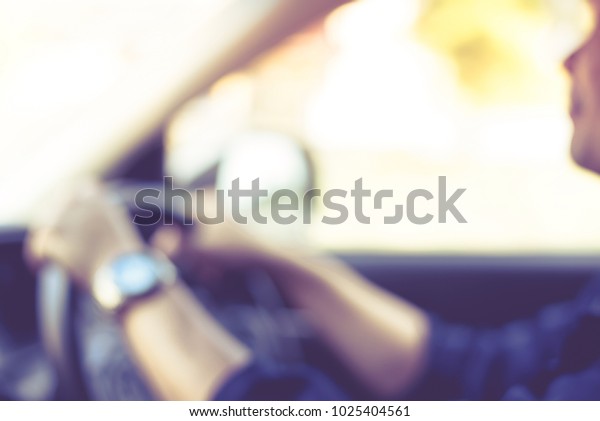 Blurred background of interior front car\
with a man drive car for travel in vintage\
style.