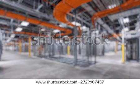 Blurred Background of Interior view of data center under construction showcasing structured cabling, raised floors, and industrial lighting for advanced technology infrastructure