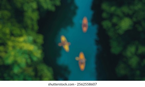 Blurred Background of Kayakers Navigate Serene River Surrounded by Lush Green Forest in Bright Yellow and Orange Canoes on a Clear Day. Blurry Background For Design Projects. - Powered by Shutterstock