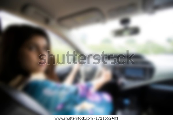 blurred background\
- lady driving private\
car