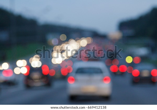 Blurred background\
with lights of cars at\
dusk