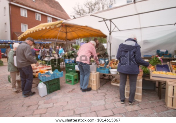 Blurred background, Local market organic fresh\
fruit,Vegetable,juice and flower shop in center city countryside \
Schwarzwald, Germany.Lifestyle in rural. Blurred people shopping in\
street market.