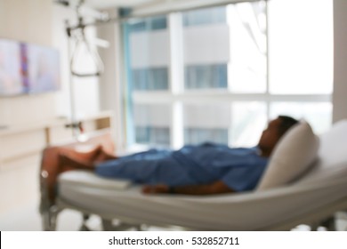 Blurred Background Male Patient Sleeping In Hospital Bed.