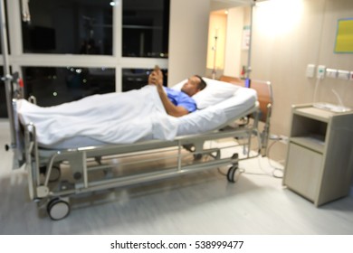 Blurred background Male Patient use smartphone on bed in hospital . - Powered by Shutterstock