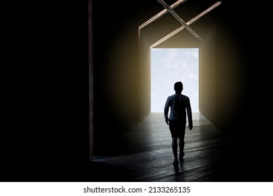 Blurred Background Man Get Out Of The Darkness, Walking Trough An Open Door. Man In Silhouette Walking Trough Different Shaped Door. Way Of Survival. Solve Problems. Solution. Choice. Tunnel. Light