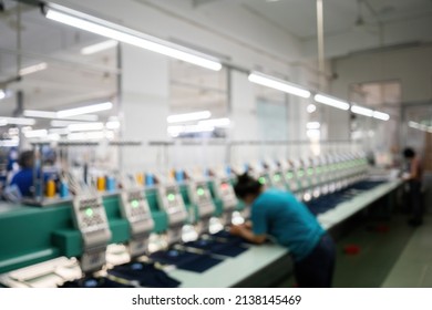 Blurred Background Modern And Automatic High Technology Sewing Machine For Textile Or Clothing Apparel Making Manufacturing Process In Industrial. Digital Textile Industry. Computerized Embroidery.