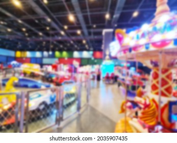 Blurred Background Of Modern Indoor Children Amusement Park. Children's Indoor Play Area In Shopping Mall. Children's Play. No People