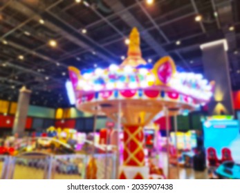 Blurred Background Of Modern Indoor Children Amusement Park. Children's Indoor Play Area In Shopping Mall. Children's Play. No People