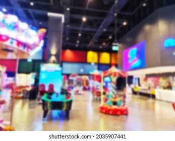 Blurred Background Of Modern Indoor Children Amusement Park. Children's Indoor Play Area In Shopping Mall. Children's Play. No People