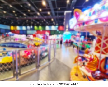 Blurred Background Of Modern Indoor Children Amusement Park. Children's Indoor Play Area In Shopping Mall. Children's Play. No People