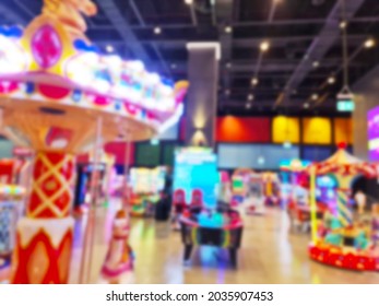 Blurred Background Of Modern Indoor Children Amusement Park. Children's Indoor Play Area In Shopping Mall. Children's Play. No People