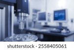 Blurred background of a modern laboratory showcasing advanced technology used in quality control. the image features precision machinery with monitors for data analysis and inspection processes.