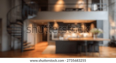 Blurred Background of Modern loft kitchen with spiral staircase, contemporary design, large windows, natural light, open space, stylish decor, and cozy ambiance in urban setting
