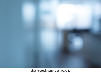 The blurred background of modern office interior with sunlight beaming through the glass windows - Shutterstock ID 2159007041