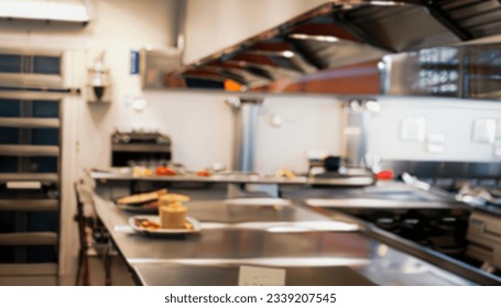 Blurred background of modern restaurant kitchen interior, shallow depth of focus