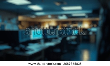 Blurred background of modern security operations center with multiple computer screens displaying data in a dimly lit environment, emphasizing technology and surveillance infrastructure