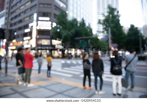 Blurred background, people crowd waiting\
traffic light beside the road for crossing the street on zebra\
crossing at crossroads in the city, Seoul\
Korea