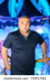 Blurred for background. People smiling and posing on cam during concert in night club party. Man and woman have fun at club. Boy and girl at night club party