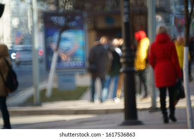 Blurred background. People walk down the street of the city.
