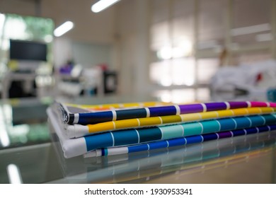 A blurred background photo of the inside of printing room. Color Palette Guide. Sample Colors Catalog. Multicolored bright background. RGB. CMYK. Printing sublimation house. Selective focus.