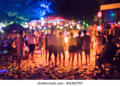 blurred background photo of many people had fun at a beach party 
