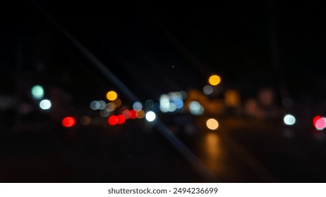 blurred background portrait of traffic lights at night - Powered by Shutterstock