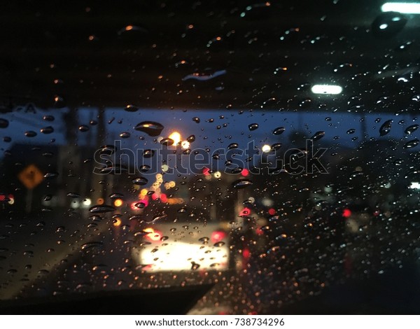 Blurred\
background, Raindrops on the windshield, street lights at night in\
rainy day, abstract of colorful\
bokeh.