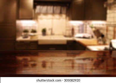 Blurred Background Of Red Kitchen Interior And Dark Brown Glasses Deck 