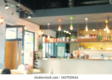 A blurred background of a restaurant or coffee shop with many decorative light at its bar counter. - Shutterstock ID 1427929616