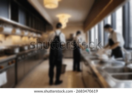 Blurred background a restaurant kitchen worker is working washing dishes after being used by customers.