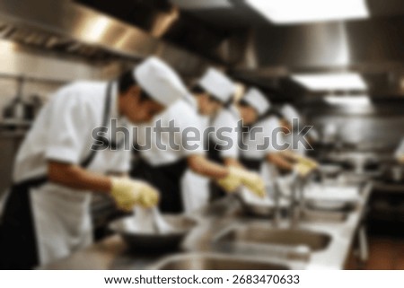 Blurred background a restaurant kitchen worker is working washing dishes after being used by customers.