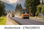 Blurred Background of Road Construction Progress with Fresh Asphalt Being Laid by Heavy Machinery and Equipment Under Cloudy Sky in Scenic Mountain Landscape