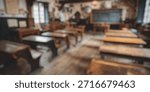 Blurred Background of Rustic Classroom Interior with Wooden Desks, Black Chalkboard, Historical Artifacts, and Vintage Decor in an Old Schoolhouse Setting