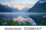 Blurred background of serene beauty of an alpine lake in glacier national park, where still waters reflect majestic mountains and vibrant wildflowers abound.