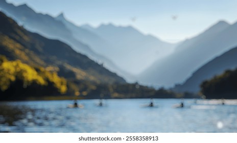 Blurred background of a serene scene depicting a group of kayakers paddling across a scenic lake surrounded by majestic mountains, capturing the beauty of outdoor adventure. - Powered by Shutterstock