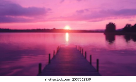 Blurred background of serene sunset over a vibrant lake, showcasing a tranquil dock extending into calm waters, blending beautiful hues of twilight and warm colors. - Powered by Shutterstock