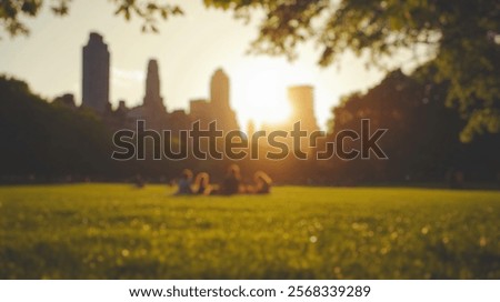 Blurred background of serene view of central park during the golden hour. the sunlight creates a warm atmosphere as people enjoy leisure on the grass.