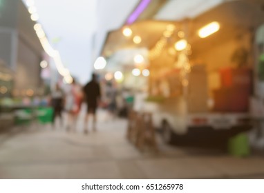 blurred background of side view mini van food trucks with orange filter and warm sunlight filter for business start up concept.