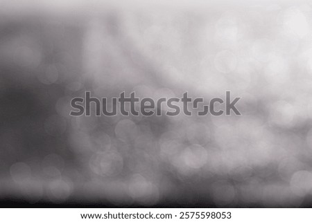 A blurred background with soft Booker effects, featuring a mix of light and dark tones, creating an abstract and dreamy atmosphere.