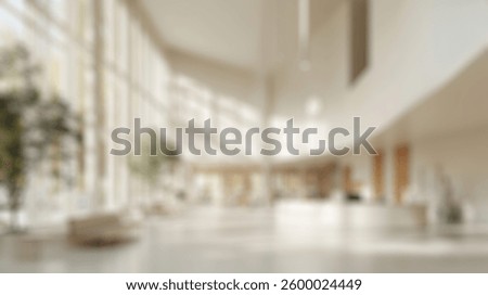 Blurred background of a spacious atrium featuring large windows that fill the area with natural light, providing a serene atmosphere for visitors and enhancing the modern architectural design.