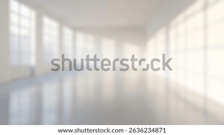 Blurred background of spacious empty industrial loft featuring large windows that fill the area with natural light, perfect for creative projects, photoshoots, or as an art studio backdrop.